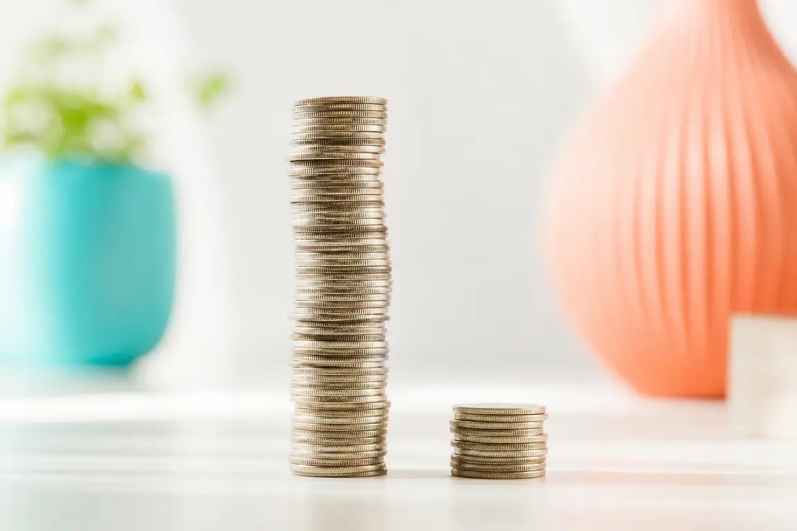 One very tall column of coins next to one short column.